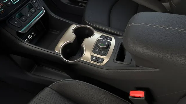 With the shifter on the center stack, the console is uncluttered, with a cubbyhole in front and, just in front of the console bin, and a phone holder with wireless charging on Denali trim.