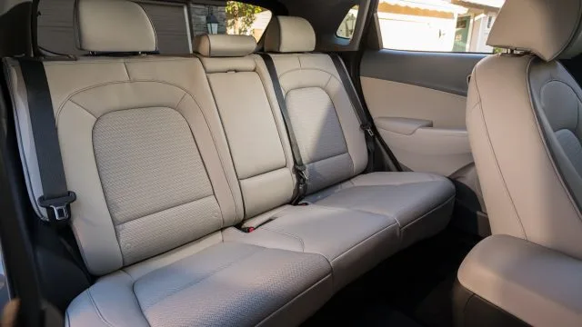 Kona EV rear legroom measures 33.4 inches, which is quite reasonable for a subcompact crossover. It’s 3 inches less than Chevrolet Bolt. Give the back seat a test sit to see how it feels.