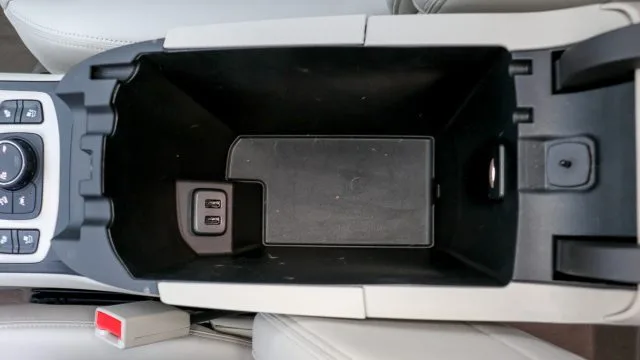 The center console bin between the front seats isn’t huge, but it does have two USB jacks on upper trim lines and an inside light.
