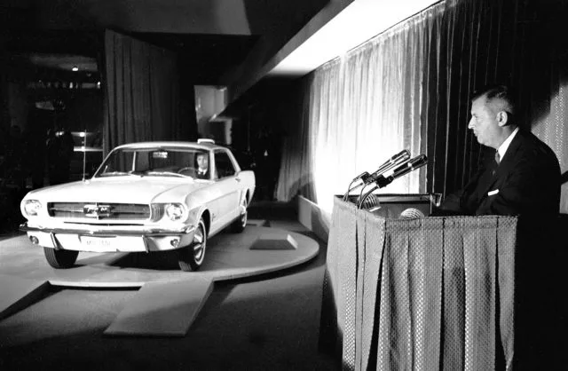 The Deuce, Henry Ford II, shows off the all-new Mustang (this from the Ford press release), New York World’s Fair, April 17, 1964. Fairgoers could ride a monorail of Mustangs above the Flushing Meadows site, near where the Mets now play.