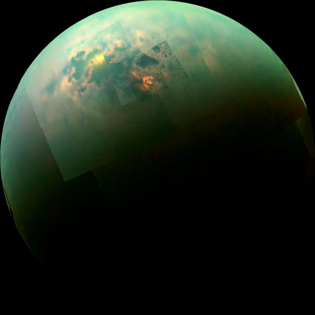 This near-infrared, color mosaic from NASA’s Cassini spacecraft shows the sun glinting off of Titan’s north polar seas. This mirror-like reflection, known as the specular point, is in the south of Titan’s largest sea, Kraken Mare, just north of an island archipelago separating two separate parts of the sea. It is also the exact color of a Pan-galactic Gargle Blaster. Credit: NASA