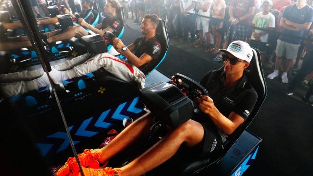 Drivers Mitch Evans of Panasonic Jaguar Racing and Jose Maria Lopez of Dragon, shown here running simulators before the street race. (Credit: Motorsport Images)