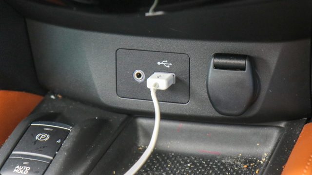 The base of the Nisan Rogue center stack has one USB jack, an aux-in jack, and a 12-volt socket.