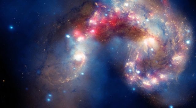 The Antennae galaxies, a composite of images from Hubble. the Chandra X-ray Observatory, and the Spitzer Space Telescope.