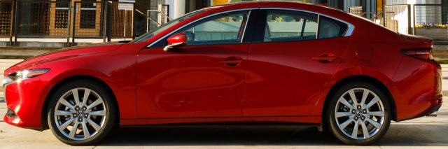 The Mazda3 Hatchback (5-Door), the gray car on top, is 8 inches shorter than the sedan (bottom), all taken off the back end. Rear legroom and headroom are about the same and the hatch holds more cargo.