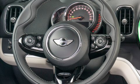 The Mini steering wheel uses small but not tiny buttons. The speedometer dominates the instrument cluster. A head-up display is offered. 