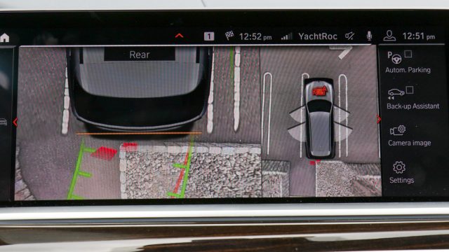 Why expensive cars are worth the money: BMW surround cameras show overhead and straight views as you park. When you get close (photo), the view ahead (or behind) morphs to an angled-down view. Slick.