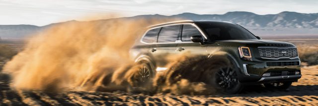 This often-used photo of the Telluride kicking up desert sands is exactly how Kia wants the car to be perceived.