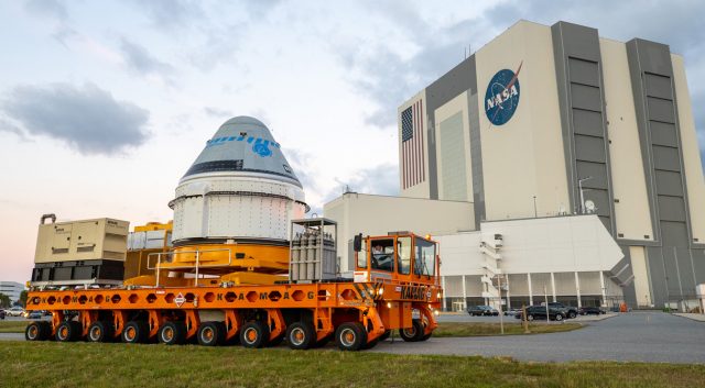 Boeing’s CST-100 Starliner spacecraft passes by the Vehicle Assembly Building at NASA’s Kennedy Space Center in Florida on Nov. 21, 2019.